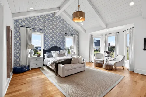 a view of a hallway with wooden floor and stairs