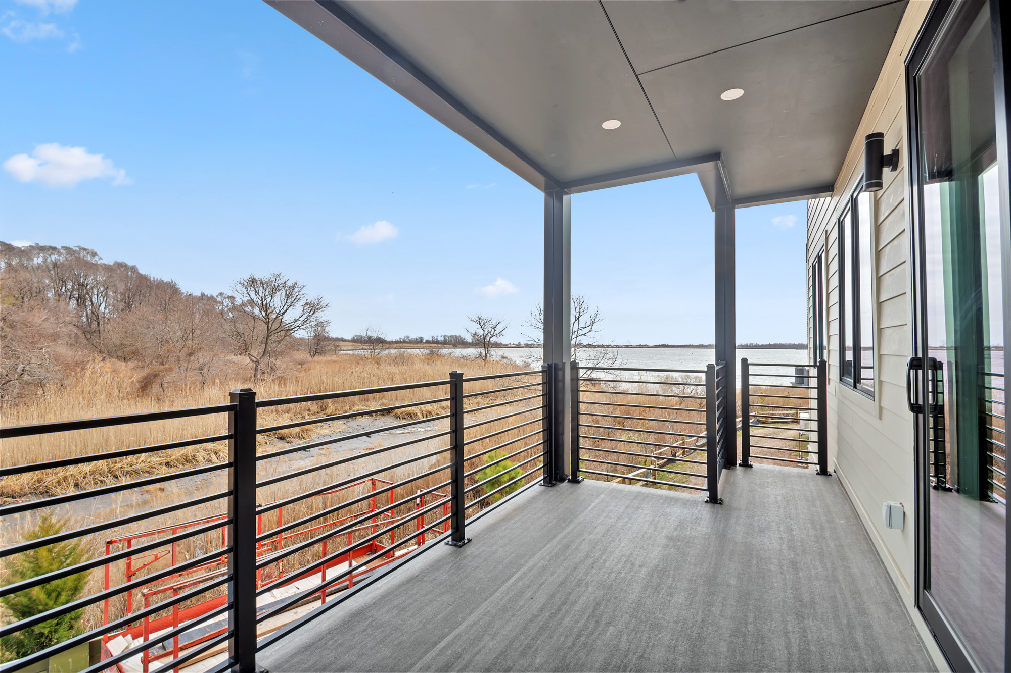 5 Osprey Court Staten Island, NY 10308 - Photo 15 of 50 a view of a balcony with floor to ceiling window and wooden floor