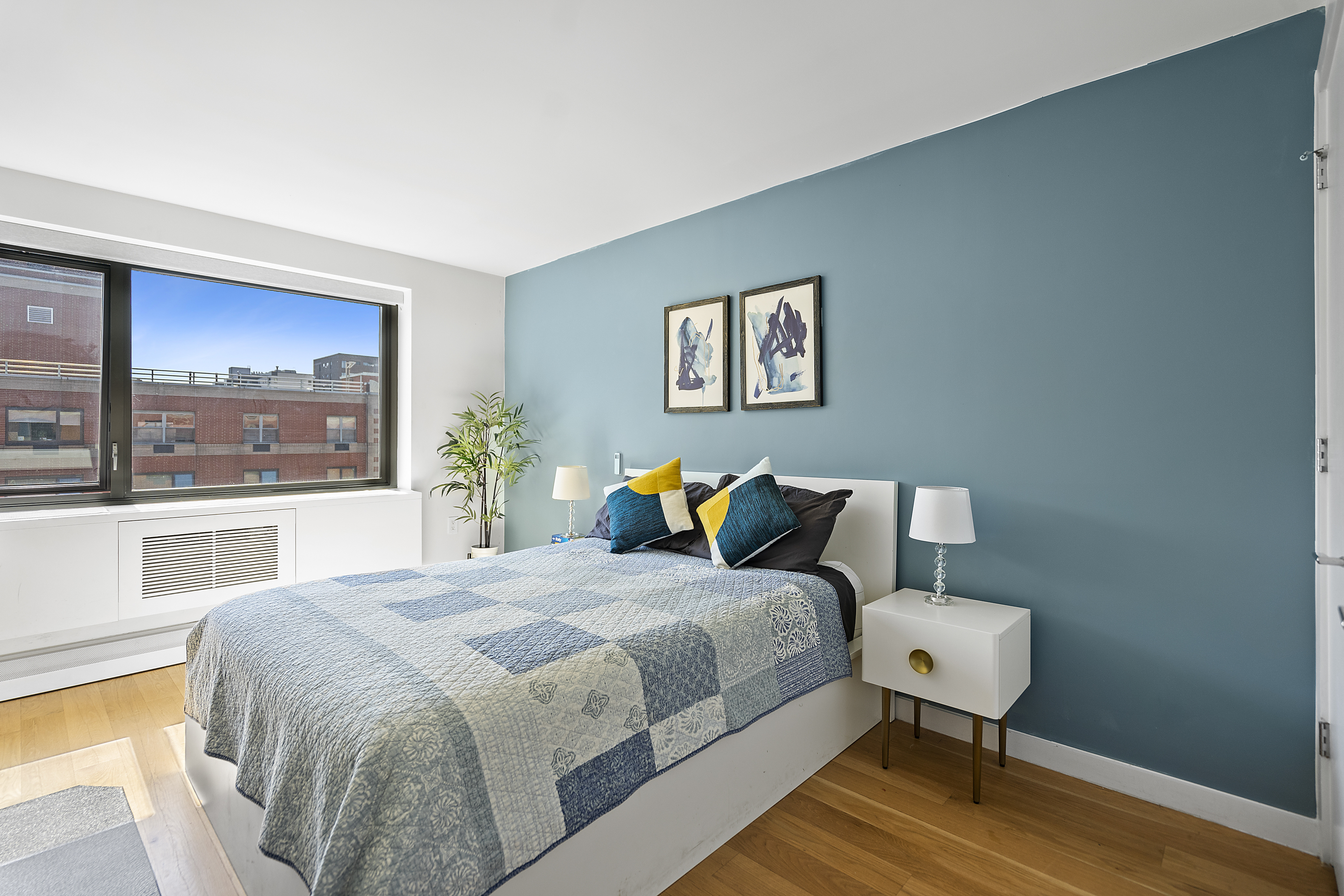 1330 5th Avenue, Unit 6H Manhattan, NY 10026 - Photo 4 of 11 a bedroom with a bed and wooden floor