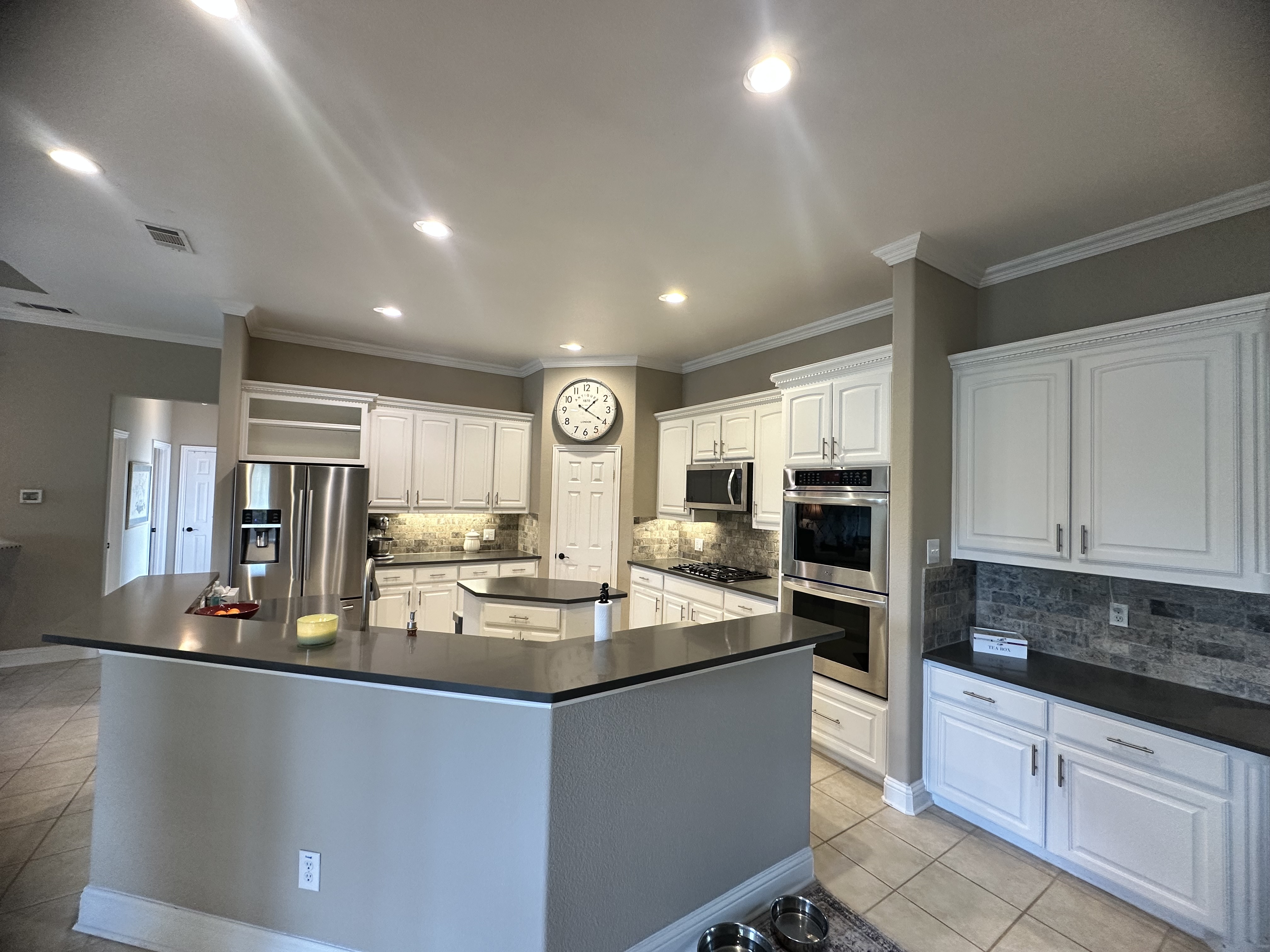 3588 Heritage Trail Celina, TX 75009 - Photo 6 of 19 a kitchen with kitchen island granite countertop a stove sink and microwave