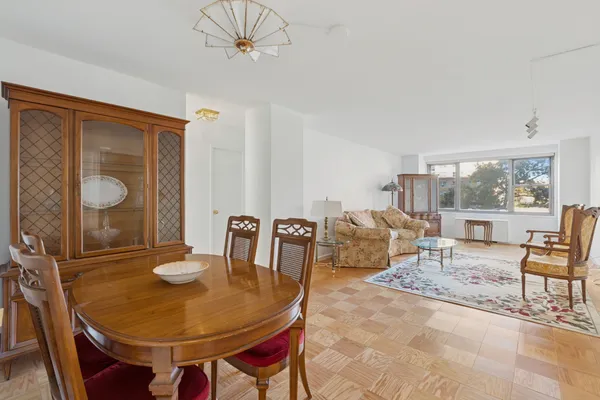 a living room with furniture a window and a table