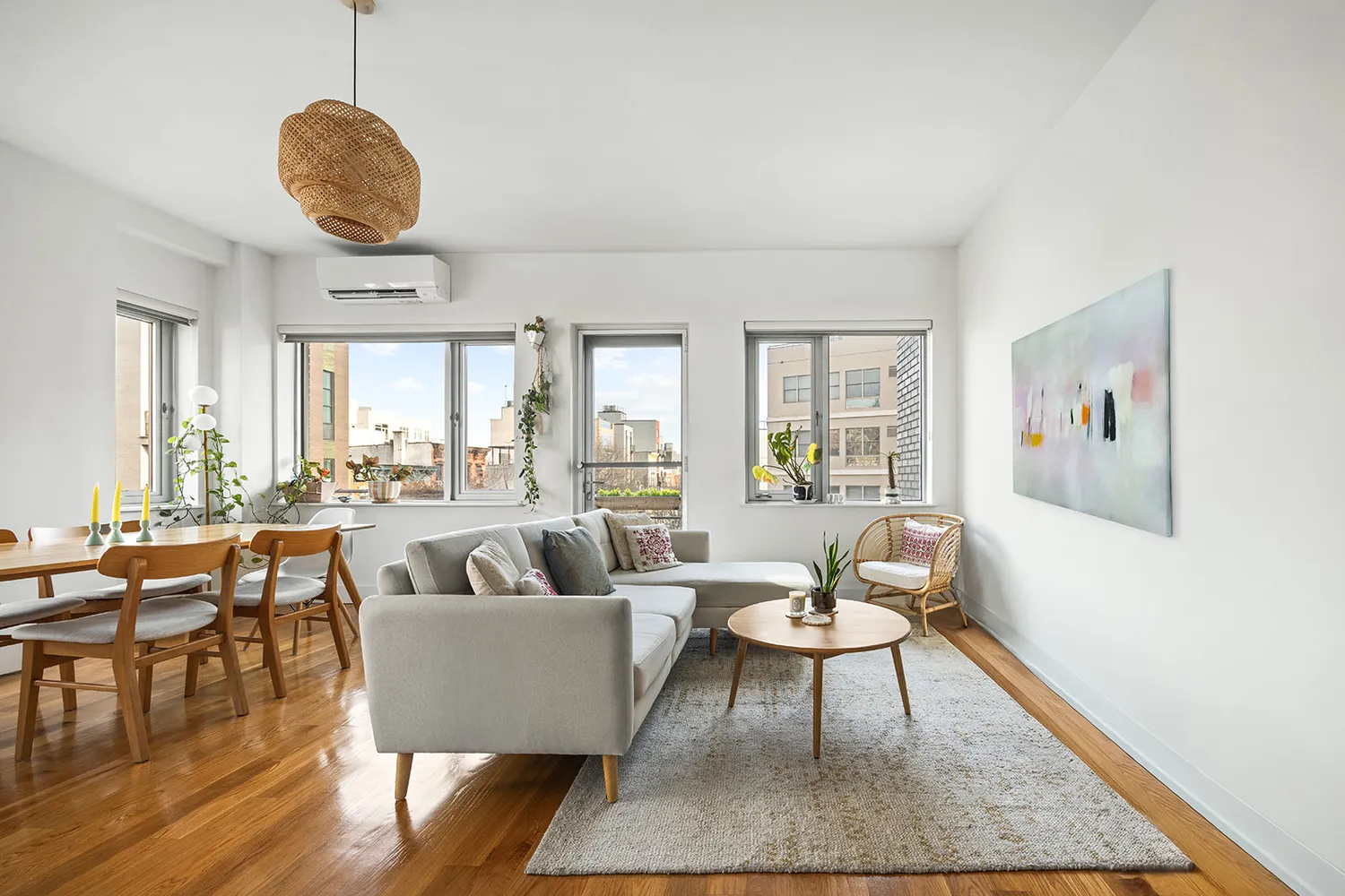 a living room with furniture a rug a lamp and a large window