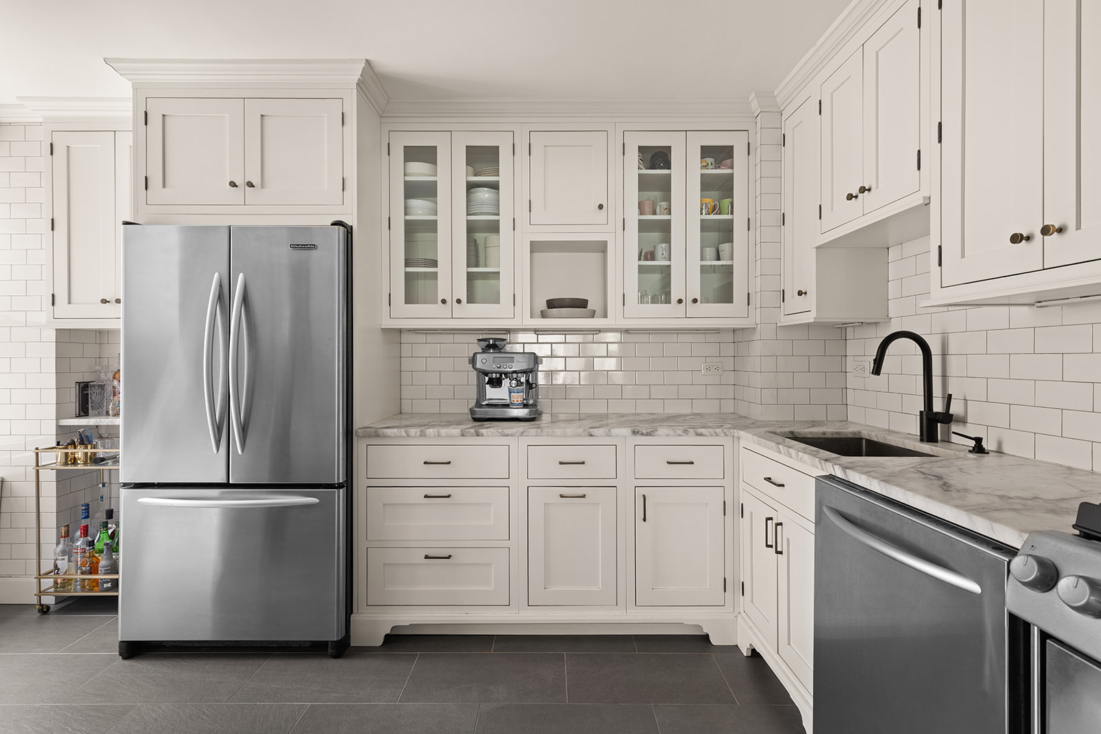 400 East 85th Street, Unit 4L Manhattan, NY 10028 - Photo 3 of 12 a kitchen with stainless steel appliances granite countertop a refrigerator sink and cabinets