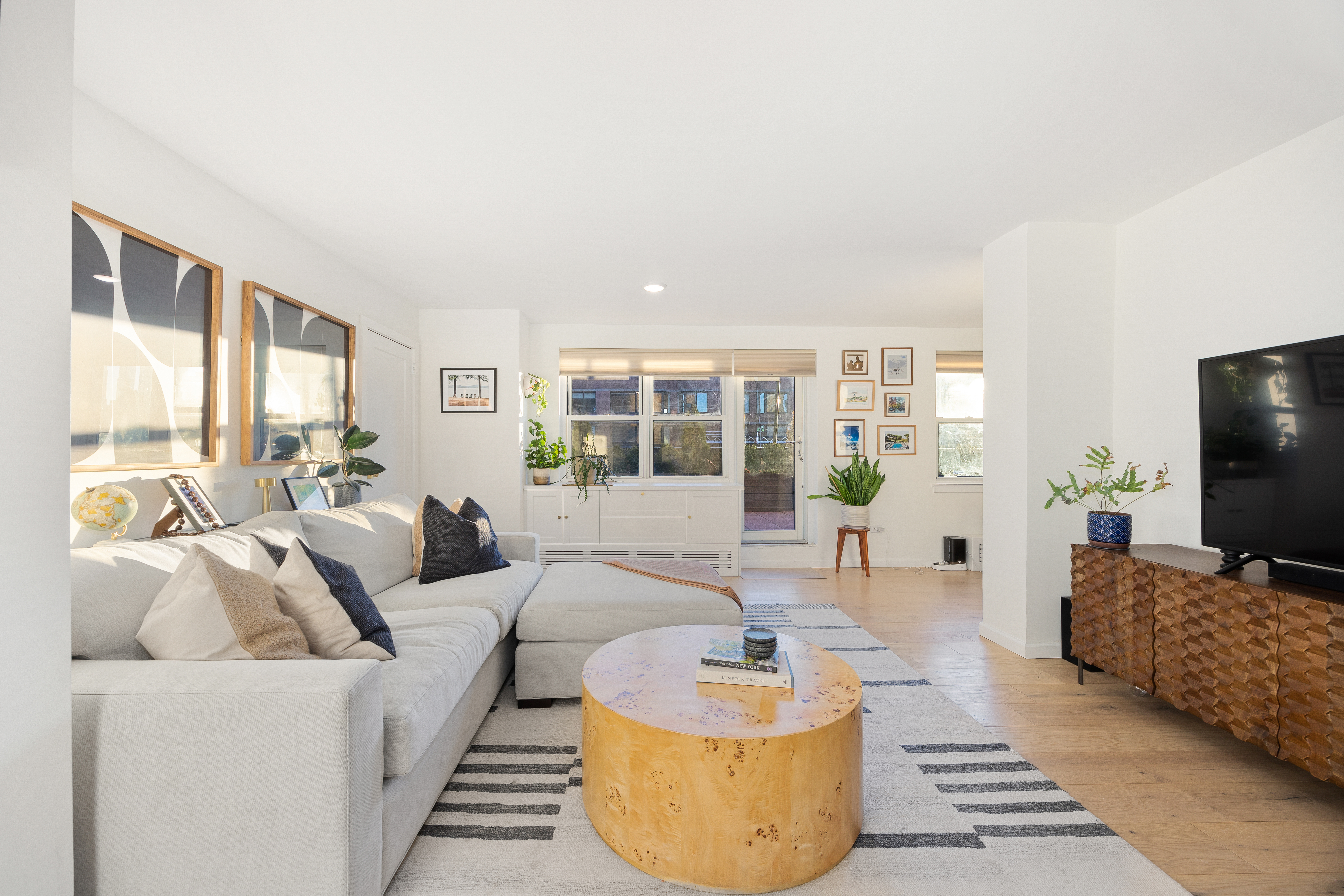 333 East 79th Street, Unit 18N Manhattan, NY 10075 - Photo 4 of 11 a living room with furniture and a flat screen tv