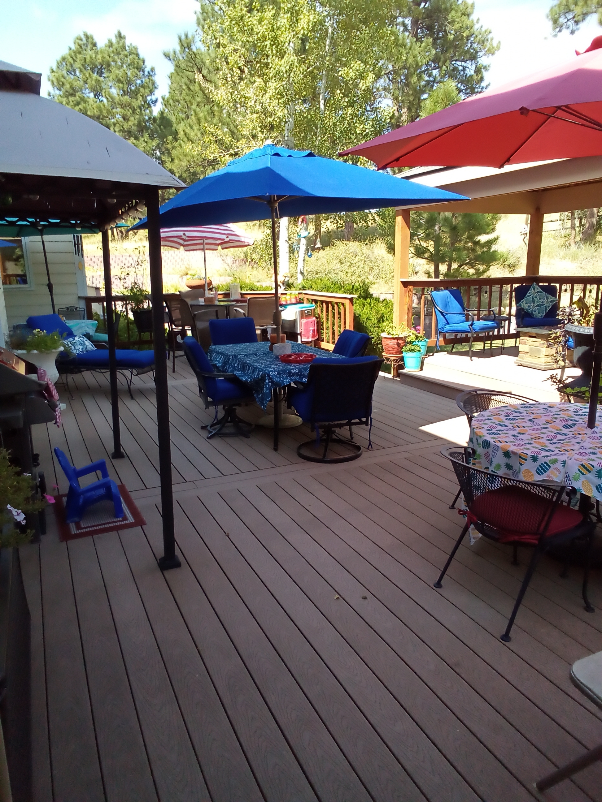 7550 North Village Road Parker, CO 80134 - Photo 11 of 13 a view of a patio with table and chairs under an umbrella