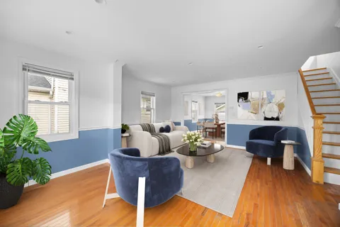 a living room with furniture and a potted plant