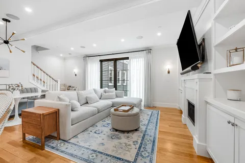 a living room with furniture fireplace and flat screen tv
