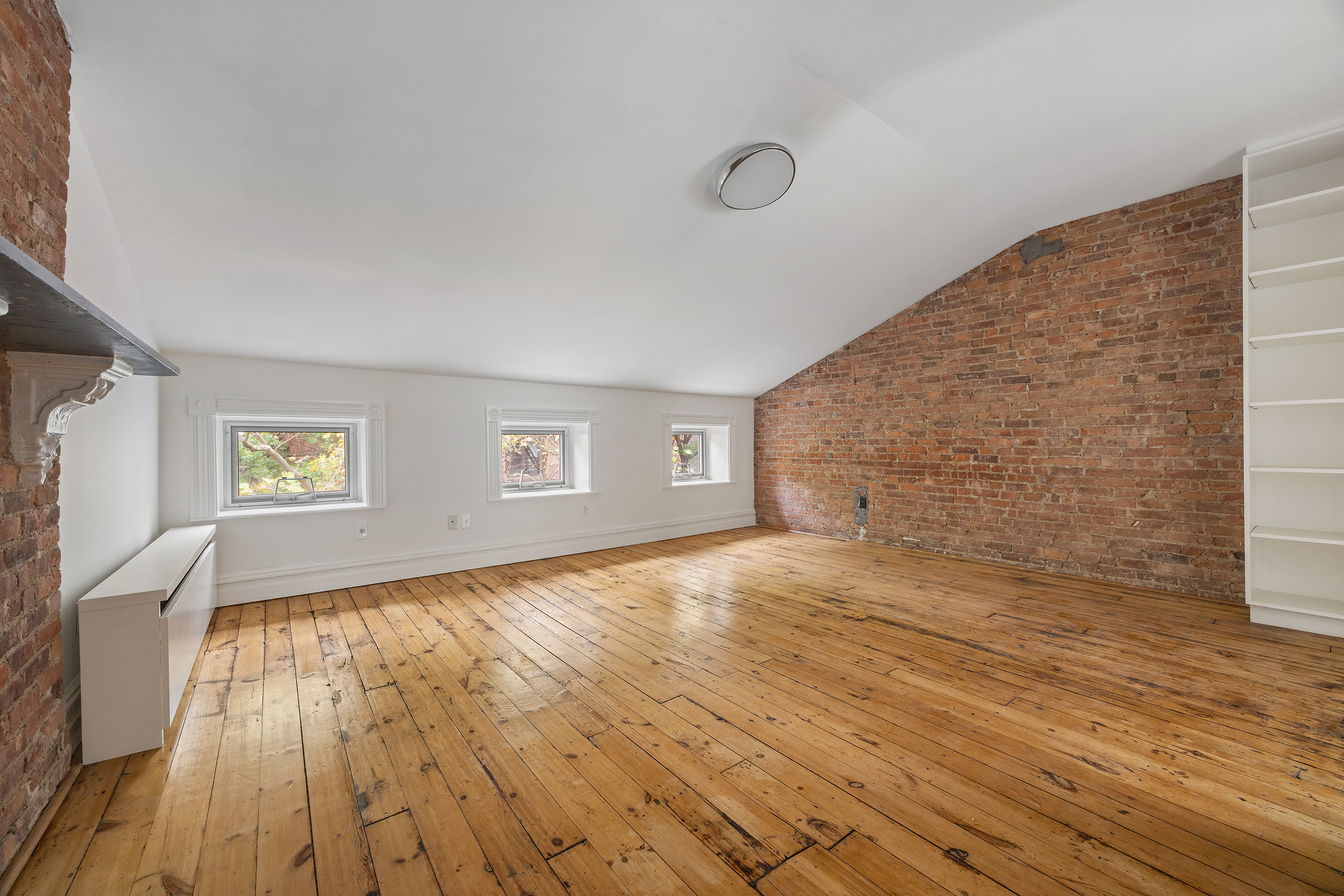 64 Clifton Place, Unit 2 Brooklyn, NY 11238 - Photo 10 of 16 a view of empty room with wooden floor and fan