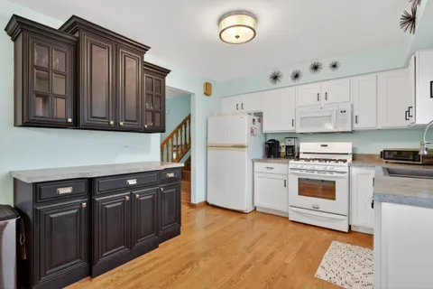 a kitchen with stainless steel appliances granite countertop a stove and a refrigerator