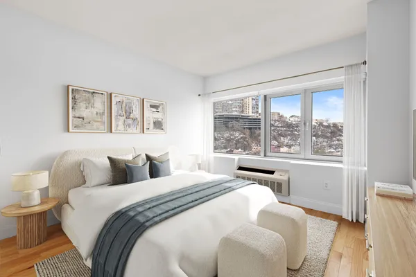 a bedroom with a bed and a large window