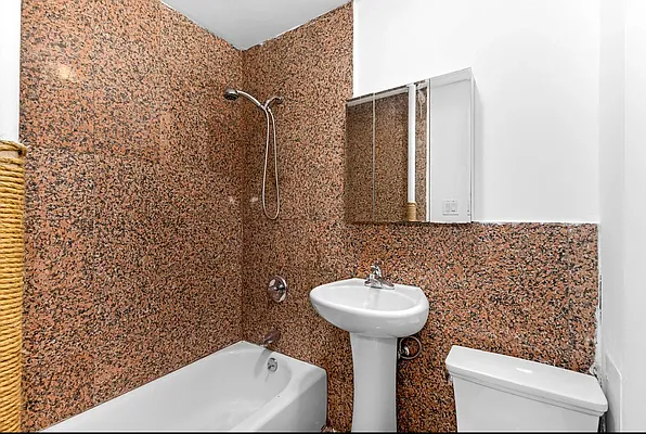 117 Mulberry Street, Unit 2 Manhattan, NY 10013 - Photo 4 of 4 a bathroom with a sink toilet and shower