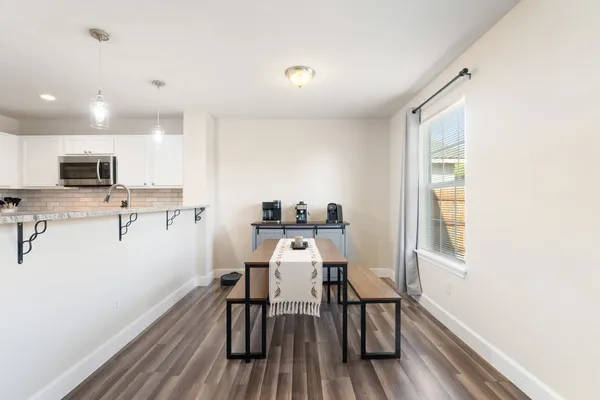 a kitchen with refrigerator a microwave a sink and cabinets