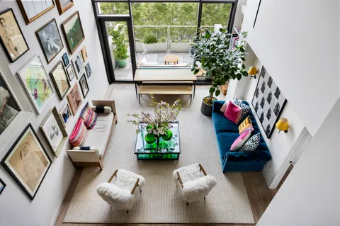 a living room with furniture a window and a flat screen tv