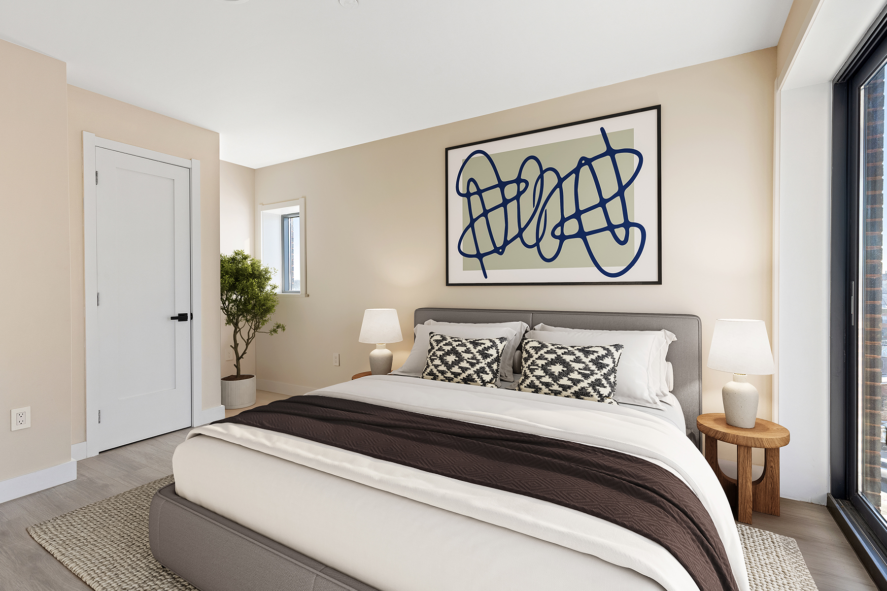 1546 Broadway, Unit 4B Brooklyn, NY 11233 - Photo 2 of 6 a bedroom with a bed and a potted plant