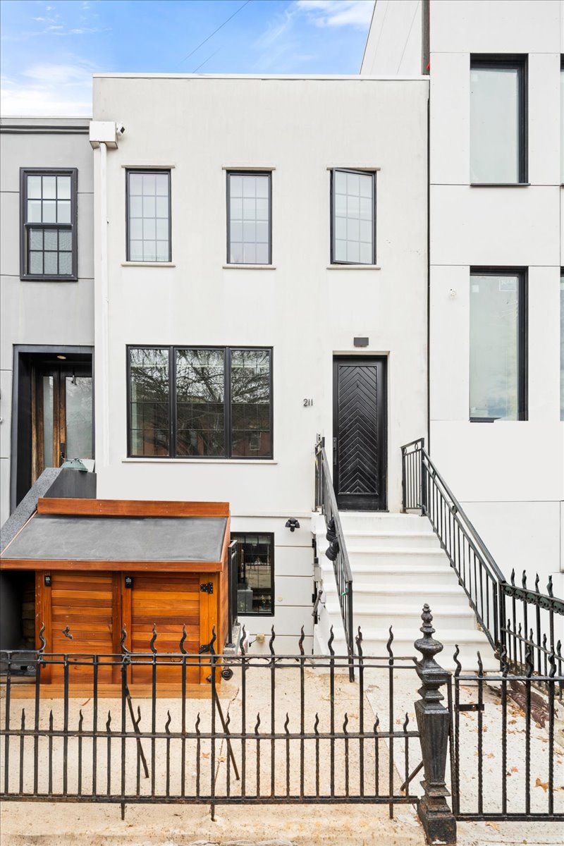 211 14th Street Brooklyn, NY 11215 - Photo 17 of 18 a living room with a large window and chandelier