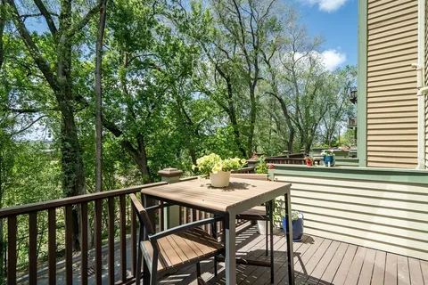 a view of a balcony with table and chairs