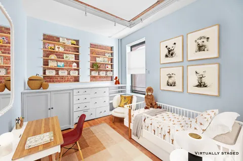 a bedroom with furniture and a window