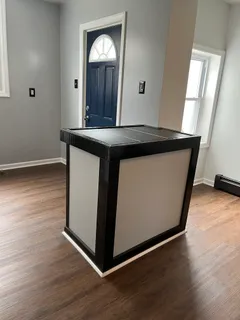 a kitchen with granite countertop a stove top oven sink and cabinets
