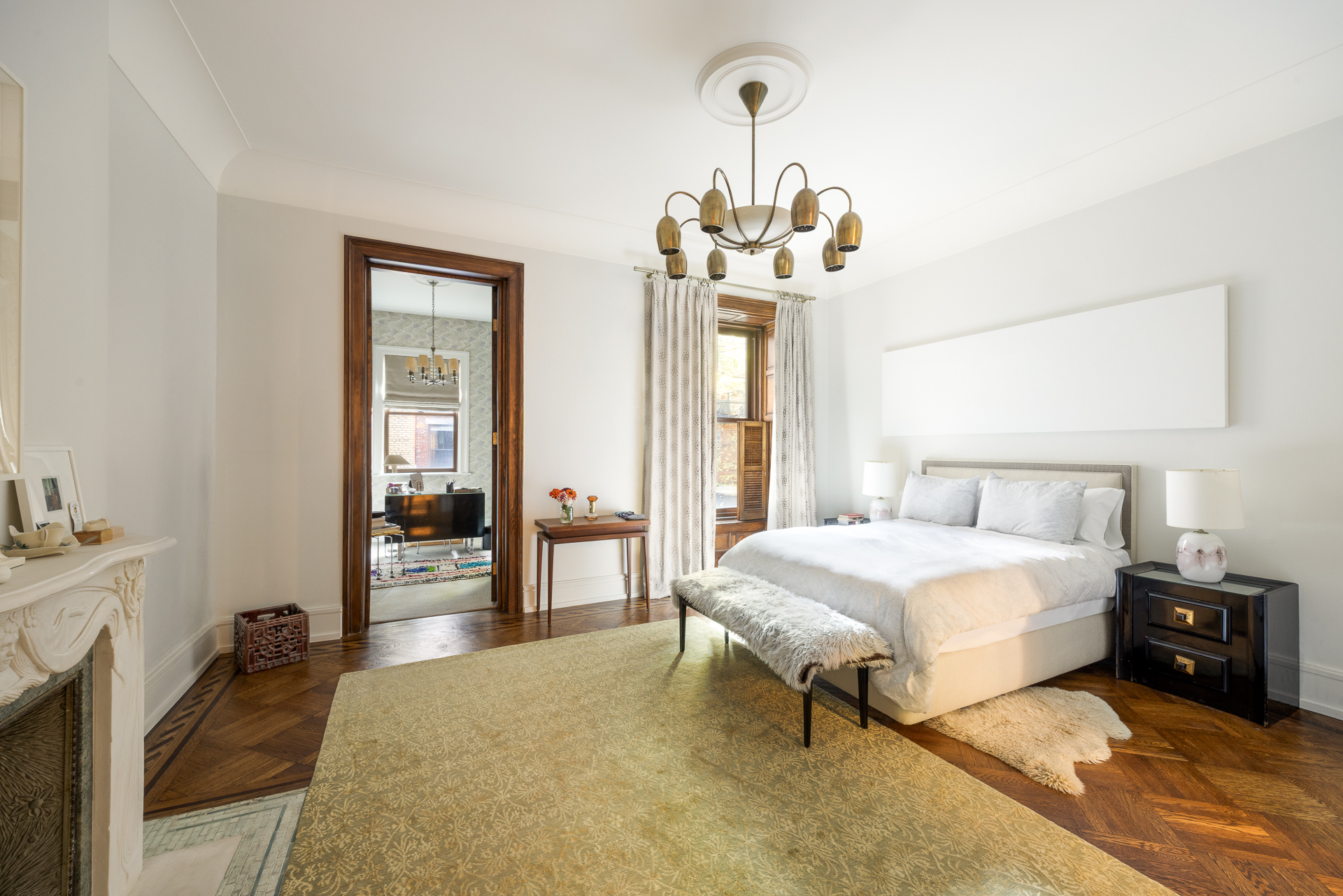 22 West 70th Street Manhattan, NY 10023 - Photo 6 of 12 a bedroom with a bed and wooden floor