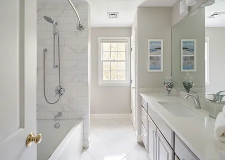 a bathroom with a tub sink and mirror