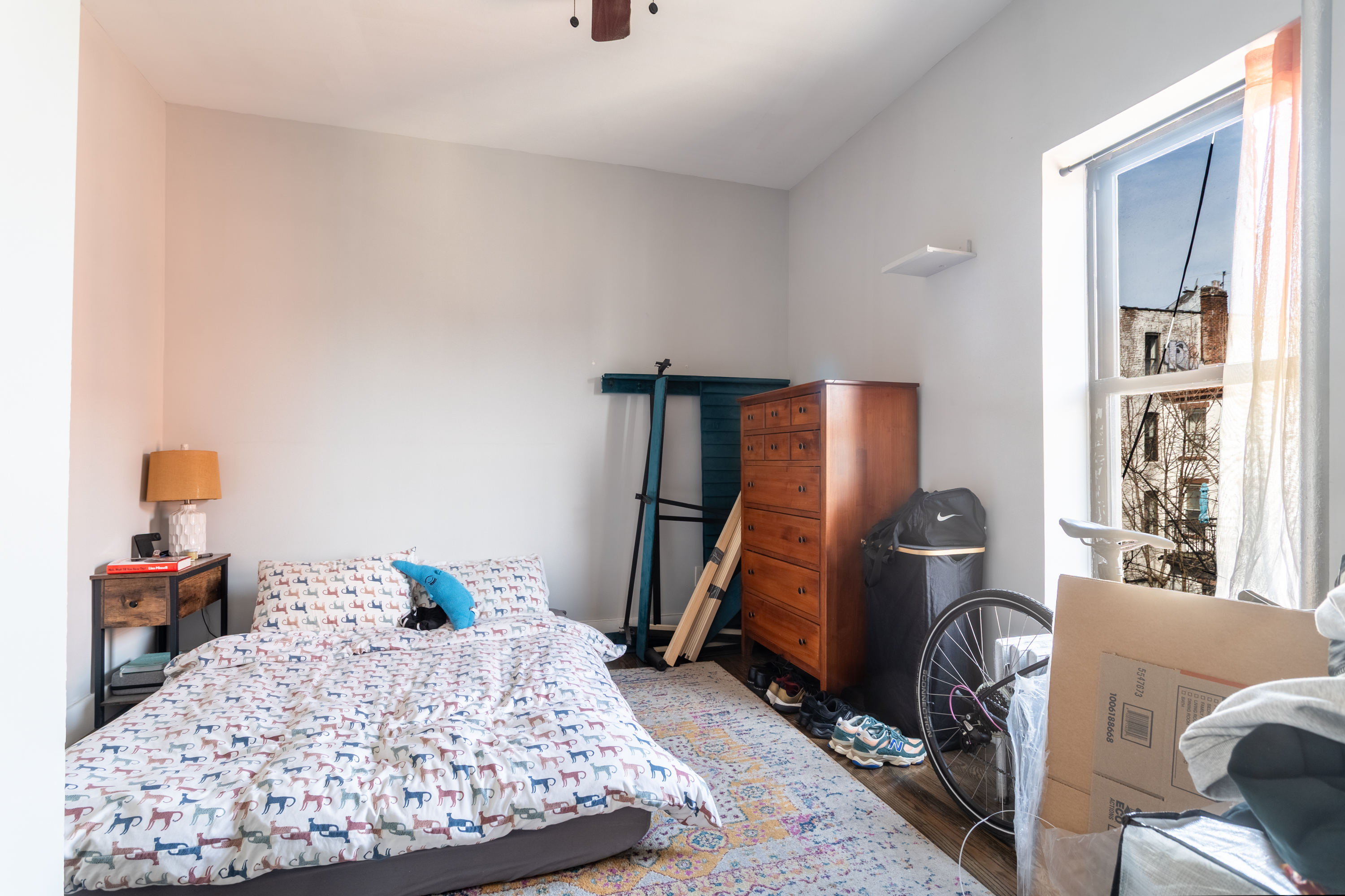 944 Marcy Avenue, Unit 3D Brooklyn, NY 11216 - Photo 6 of 9 a bedroom with a bed and wooden floor