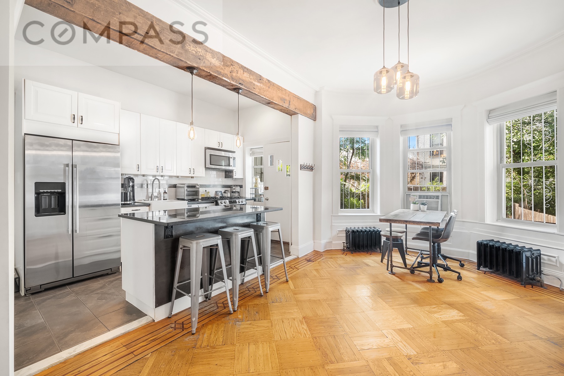 69 Sterling Street Brooklyn, NY 11225 - Photo 3 of 14 a kitchen with stainless steel appliances granite countertop a stove and a refrigerator