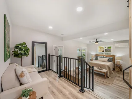 a living room with furniture and a wooden floor