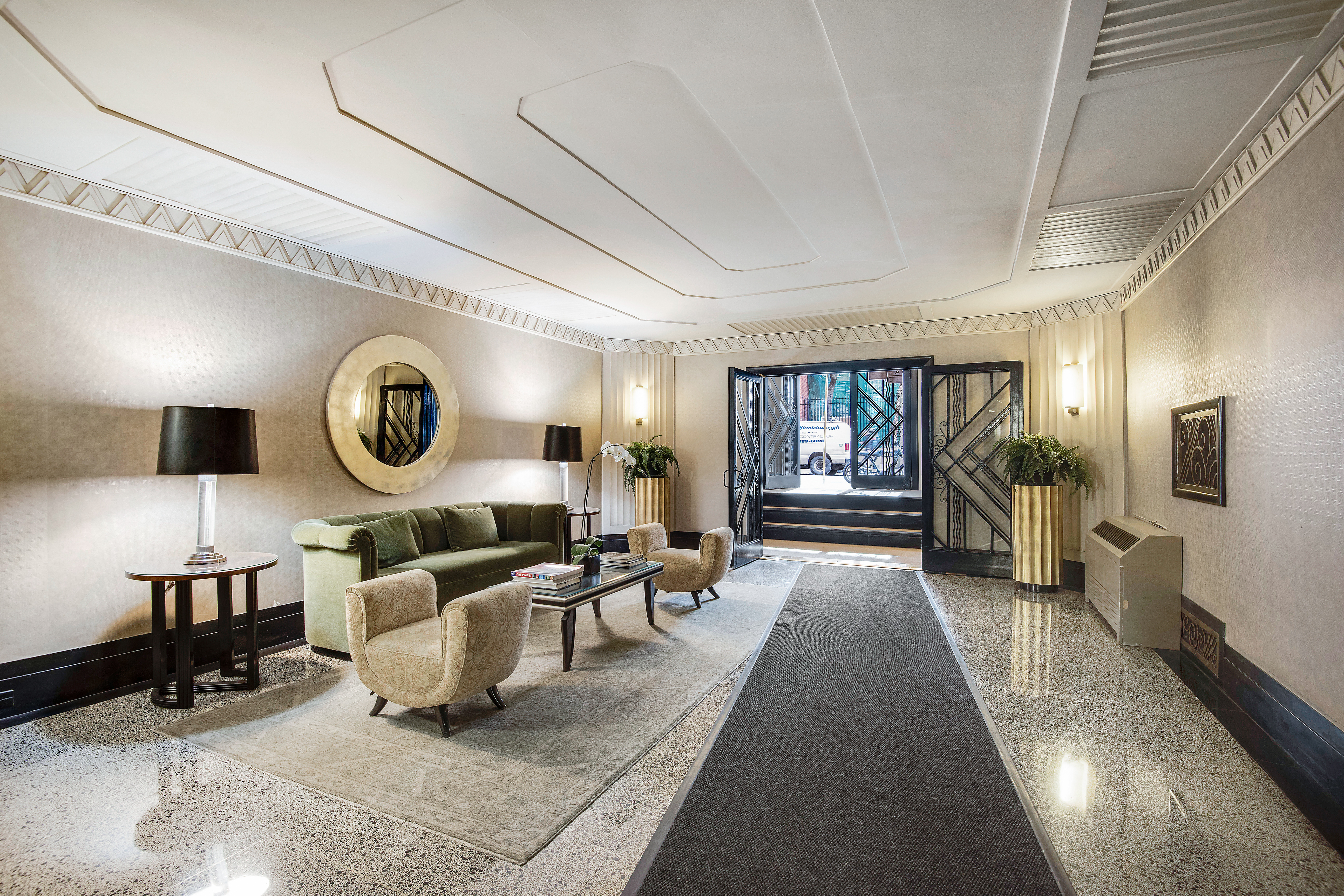 434 East 52nd Street, Unit 1BH Manhattan, NY 10022 - Photo 18 of 23 a living room with furniture a mirror and a large window