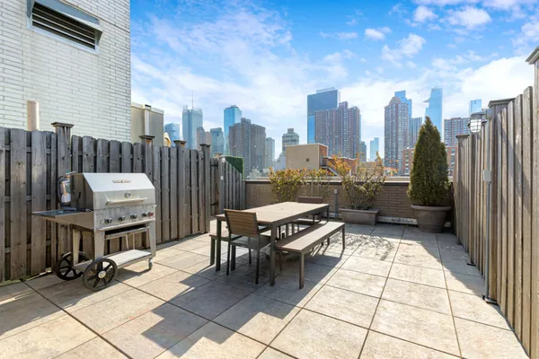 a terrace with outdoor seating and city view