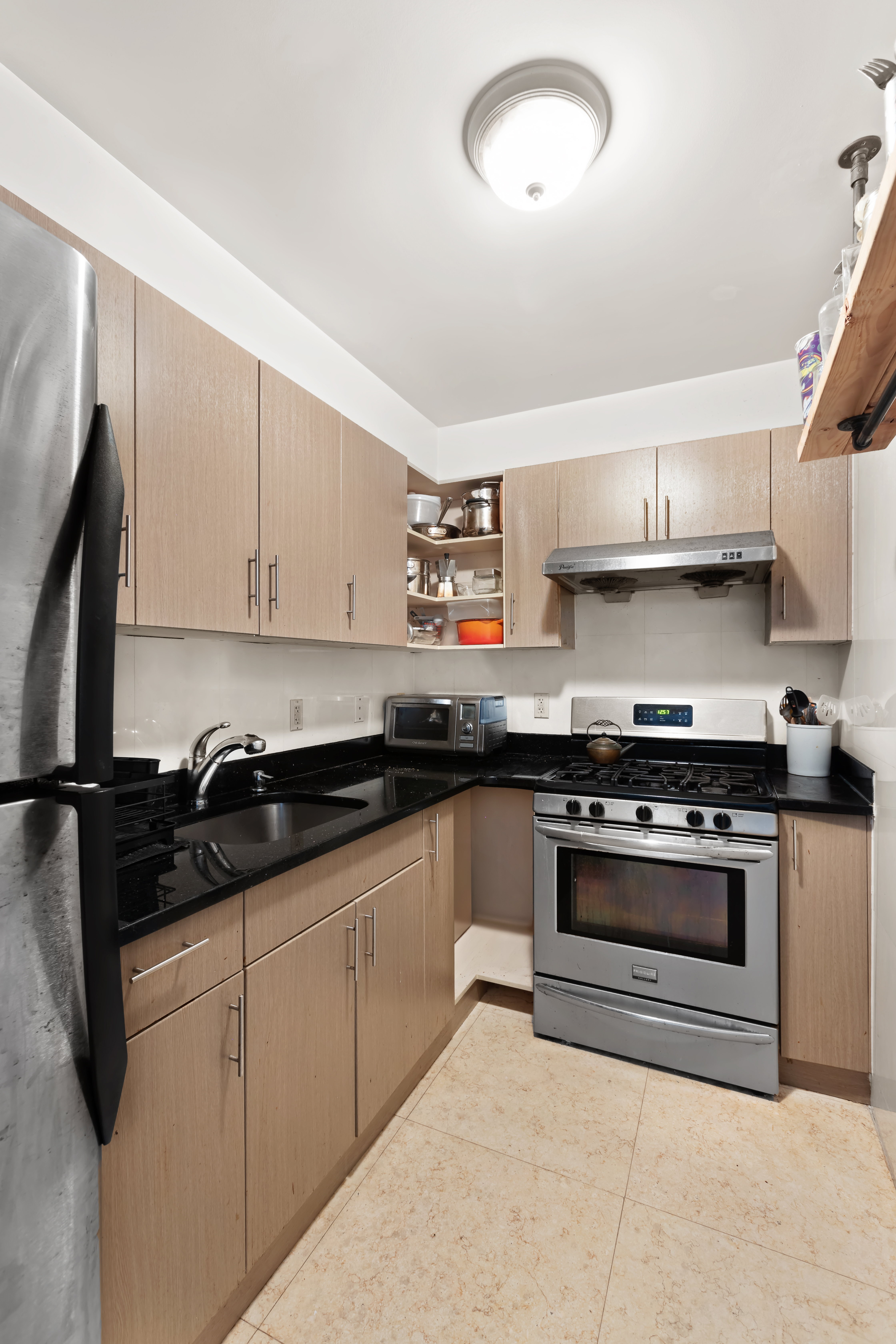 228 Bushwick Avenue, Unit 6A Brooklyn, NY 11206 - Photo 6 of 8 a kitchen with granite countertop a stove and a sink