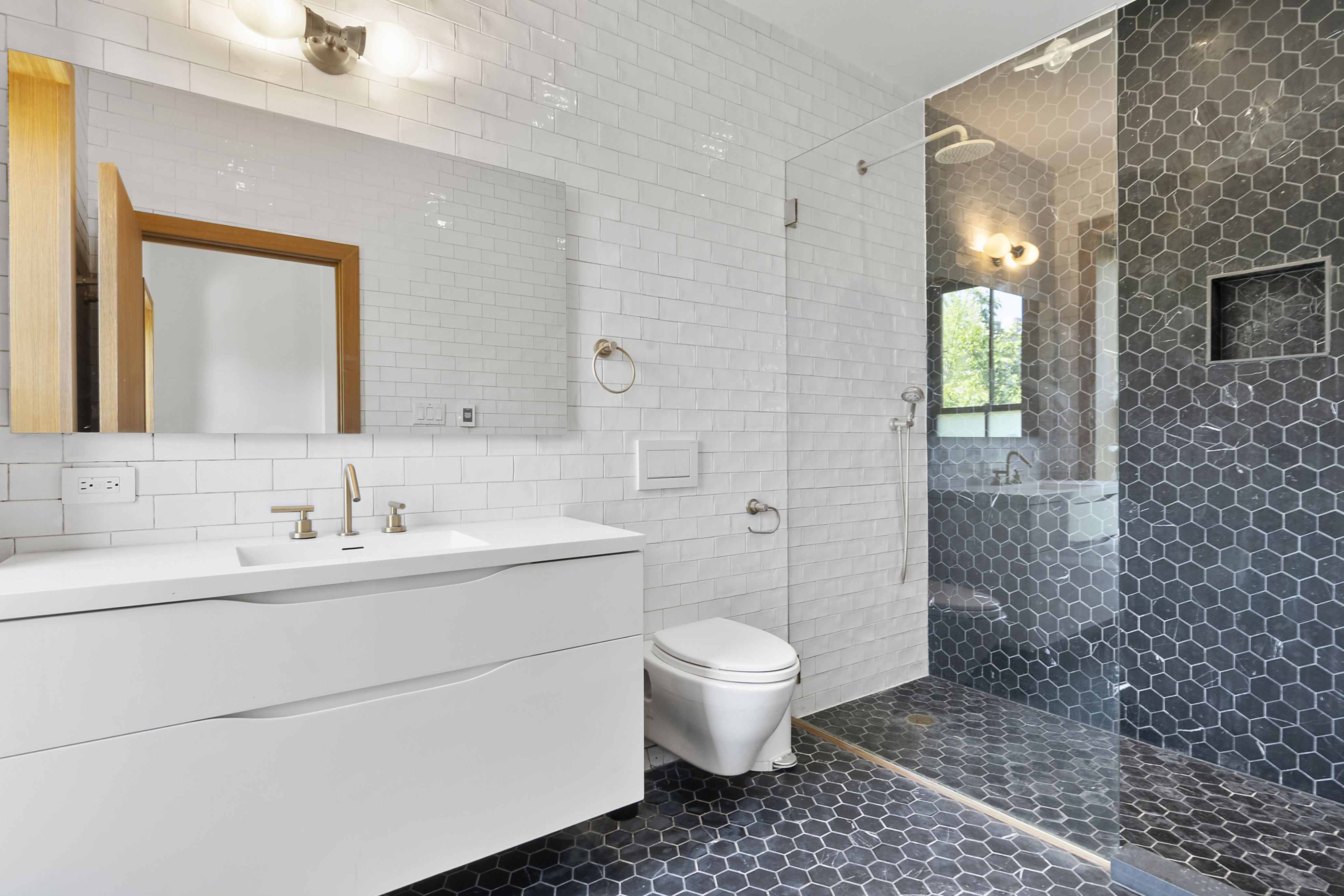 87 Monroe Street Brooklyn, NY 11216 - Photo 9 of 26 a bathroom with a sink a toilet and shower