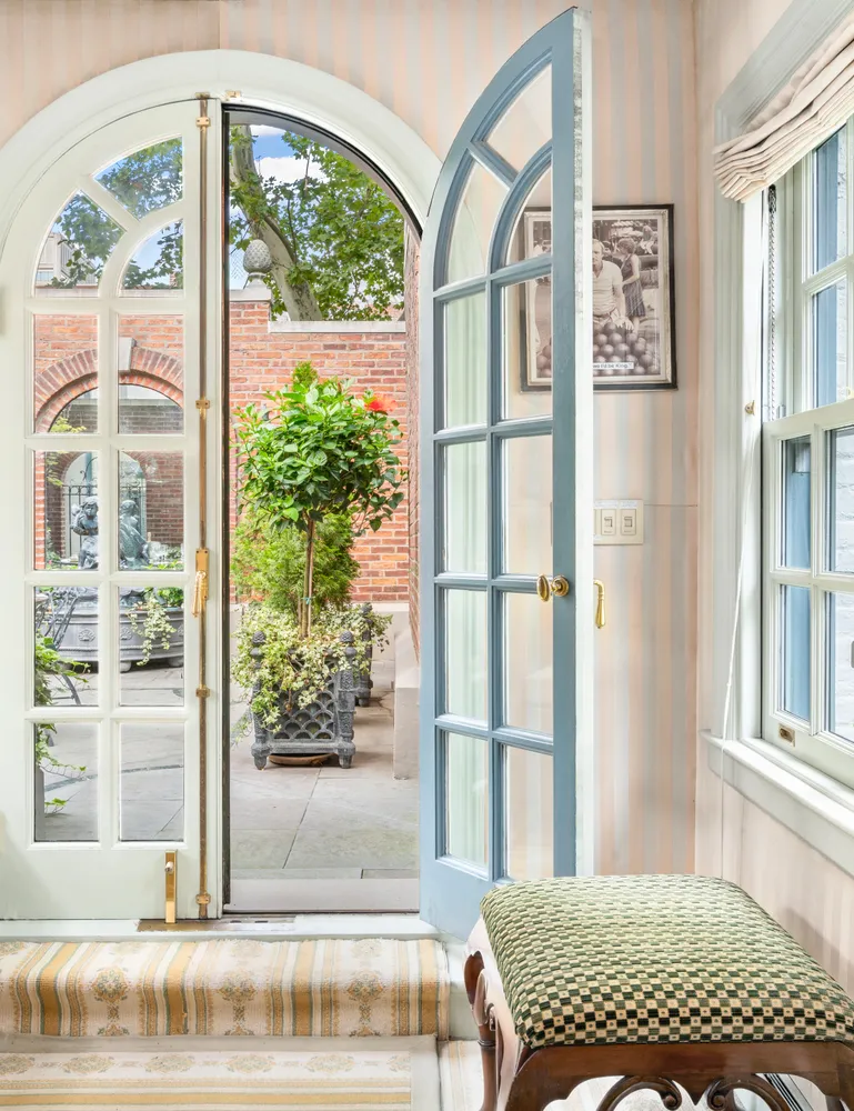 a view of patio with a table and chairs and potted plants