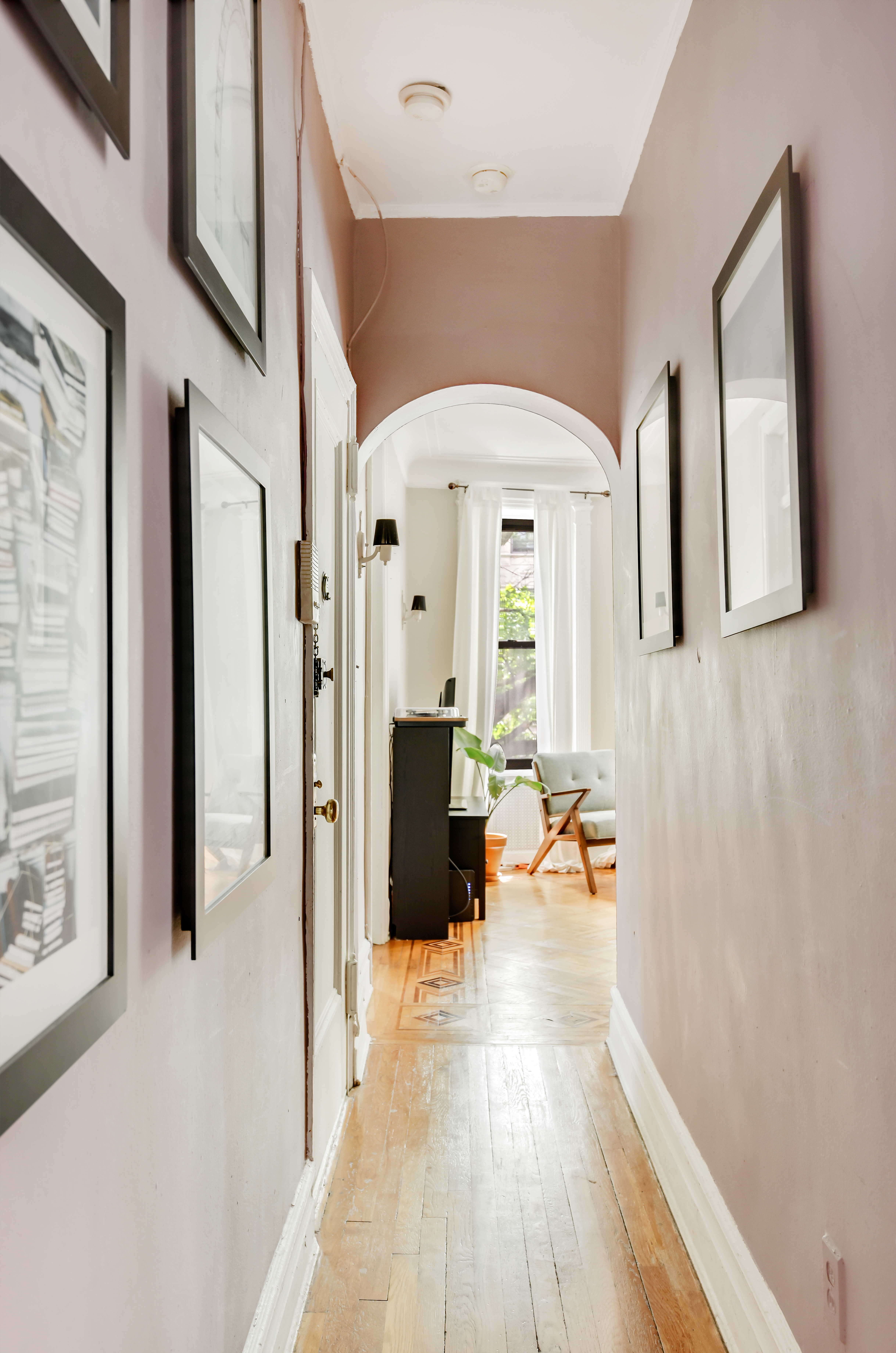 408 8th Avenue, Unit 3B Brooklyn, NY 11215 - Photo 2 of 5 a view of a hallway with wooden floor and furniture