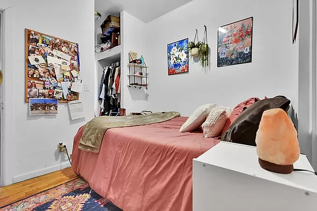 416 East 71st Street, Unit 17 Manhattan, NY 10021 - Photo 4 of 8 a bedroom with bed and wall painting