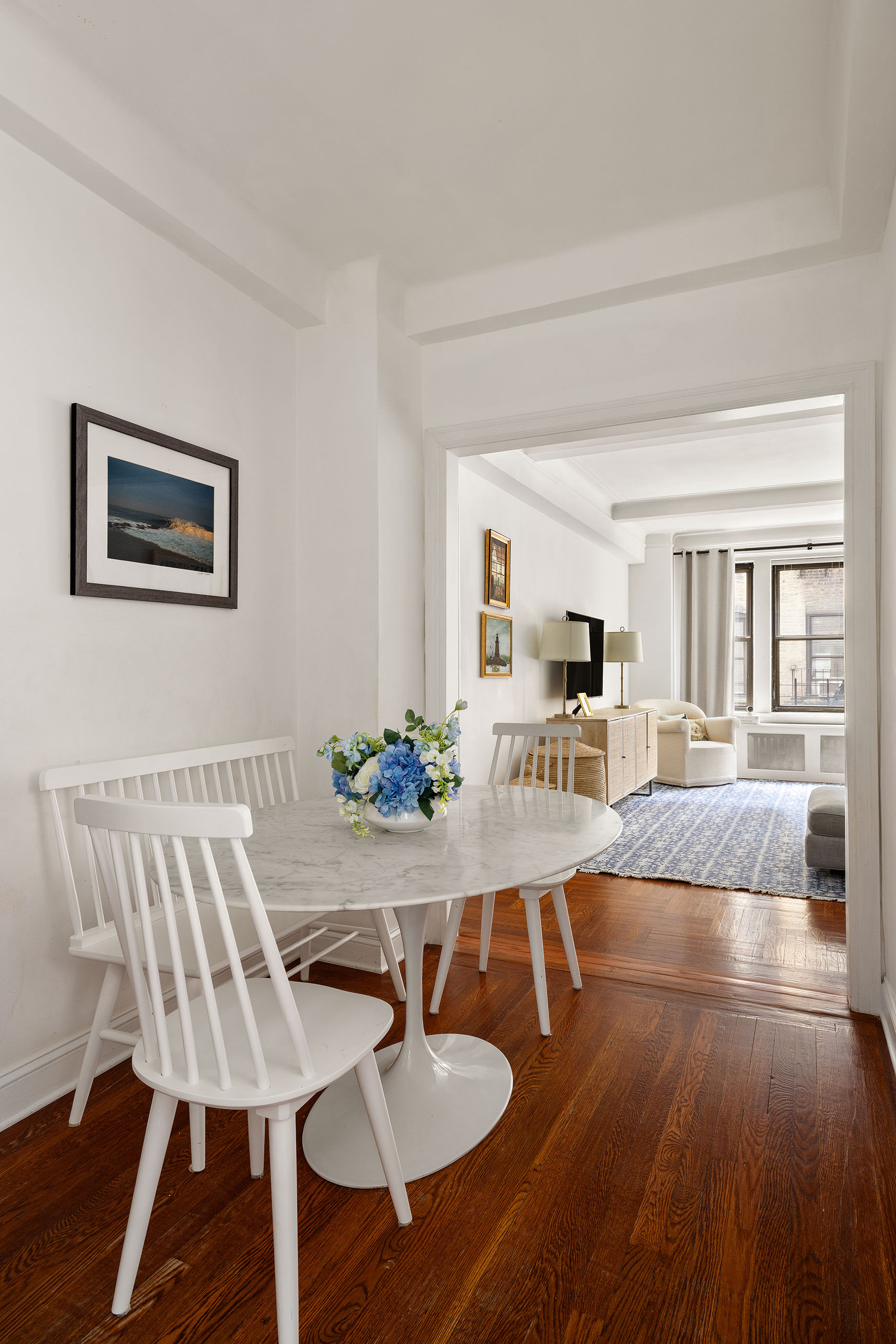 60 East 96th Street, Unit 6C Manhattan, NY 10128 - Photo 3 of 9 a view of a dining room with furniture and wooden floor