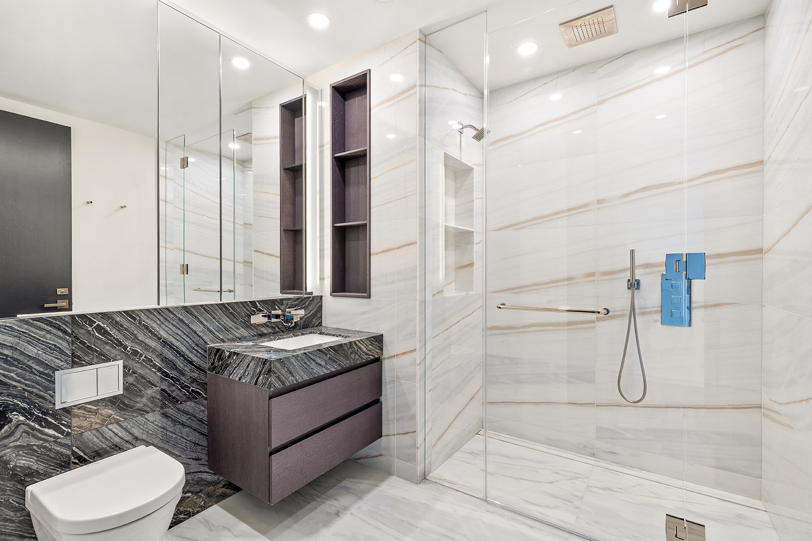 125 Greenwich Street, Unit 61C Manhattan, NY 10006 - Photo 6 of 16 a bathroom with a granite countertop sink a toilet and shower