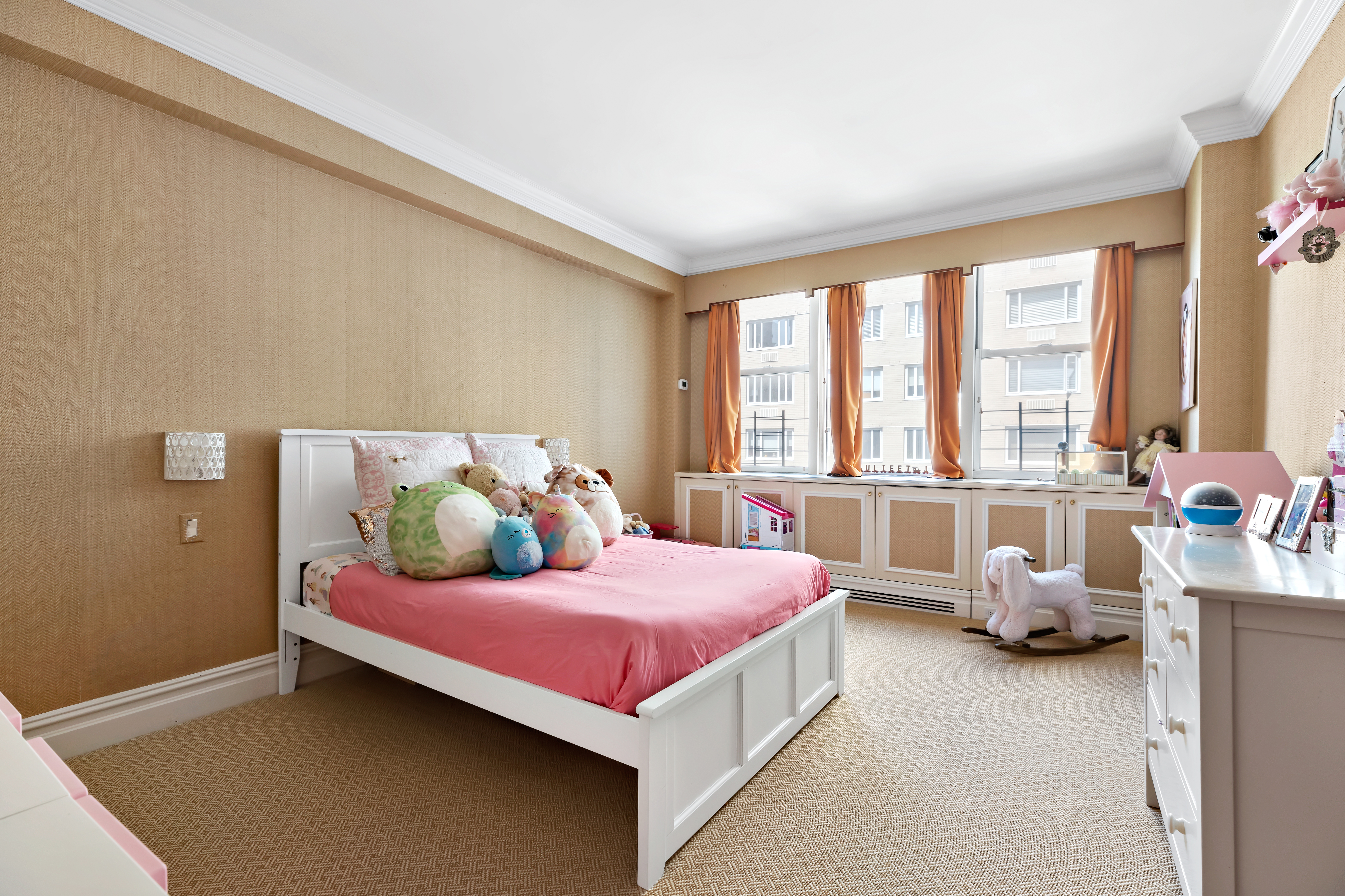 175 East 62nd Street, Unit 9D Manhattan, NY 10065 - Photo 10 of 12 a bedroom with a bed and large windows