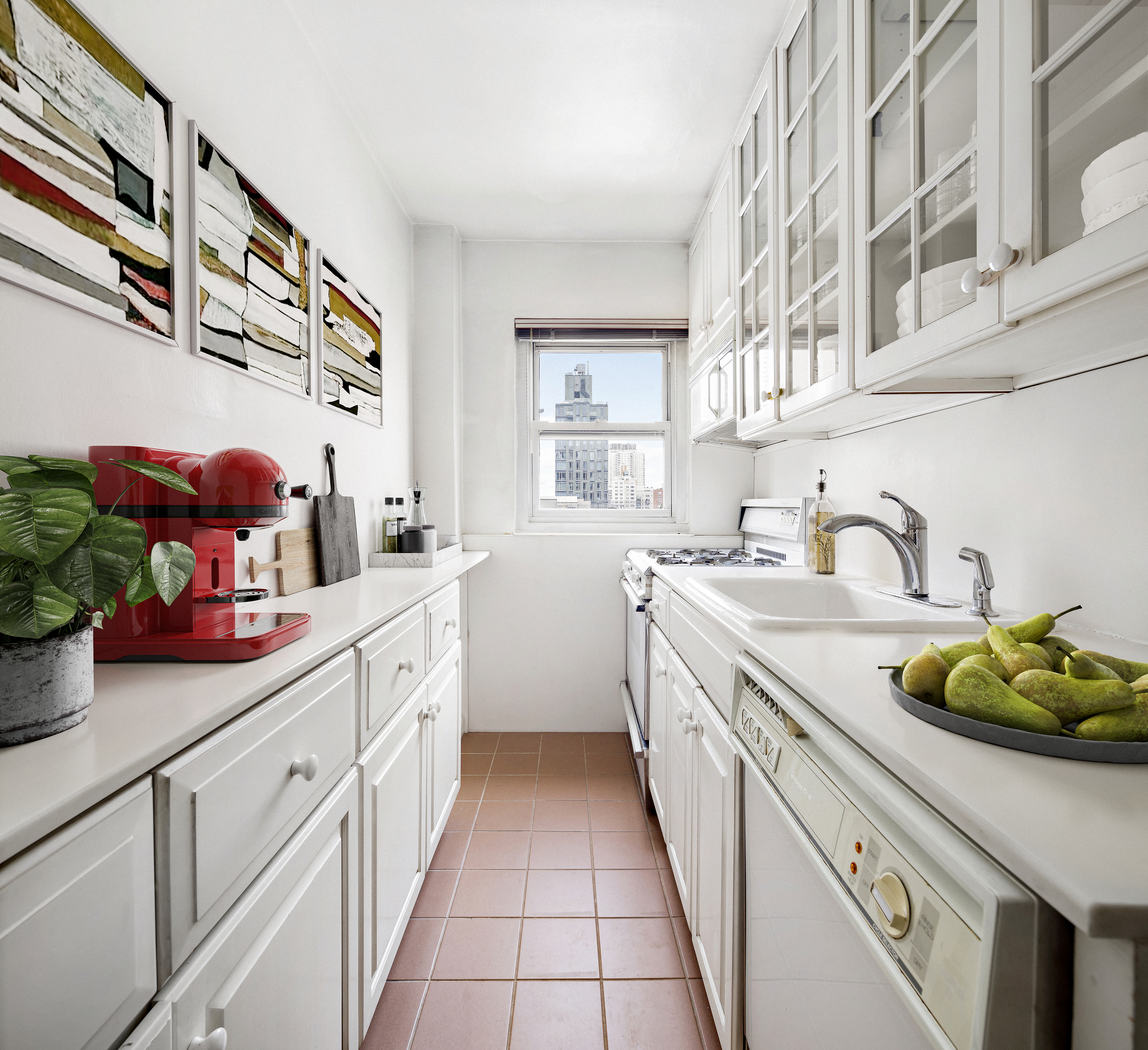 205 East 77th Street, Unit 10B Manhattan, NY 10075 - Photo 4 of 6 a kitchen with cabinets a sink and appliances