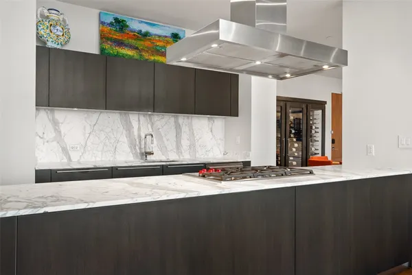 a kitchen with a sink a stove and cabinets