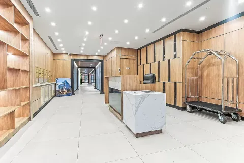 a living room with stainless steel appliances furniture a rug and a large window