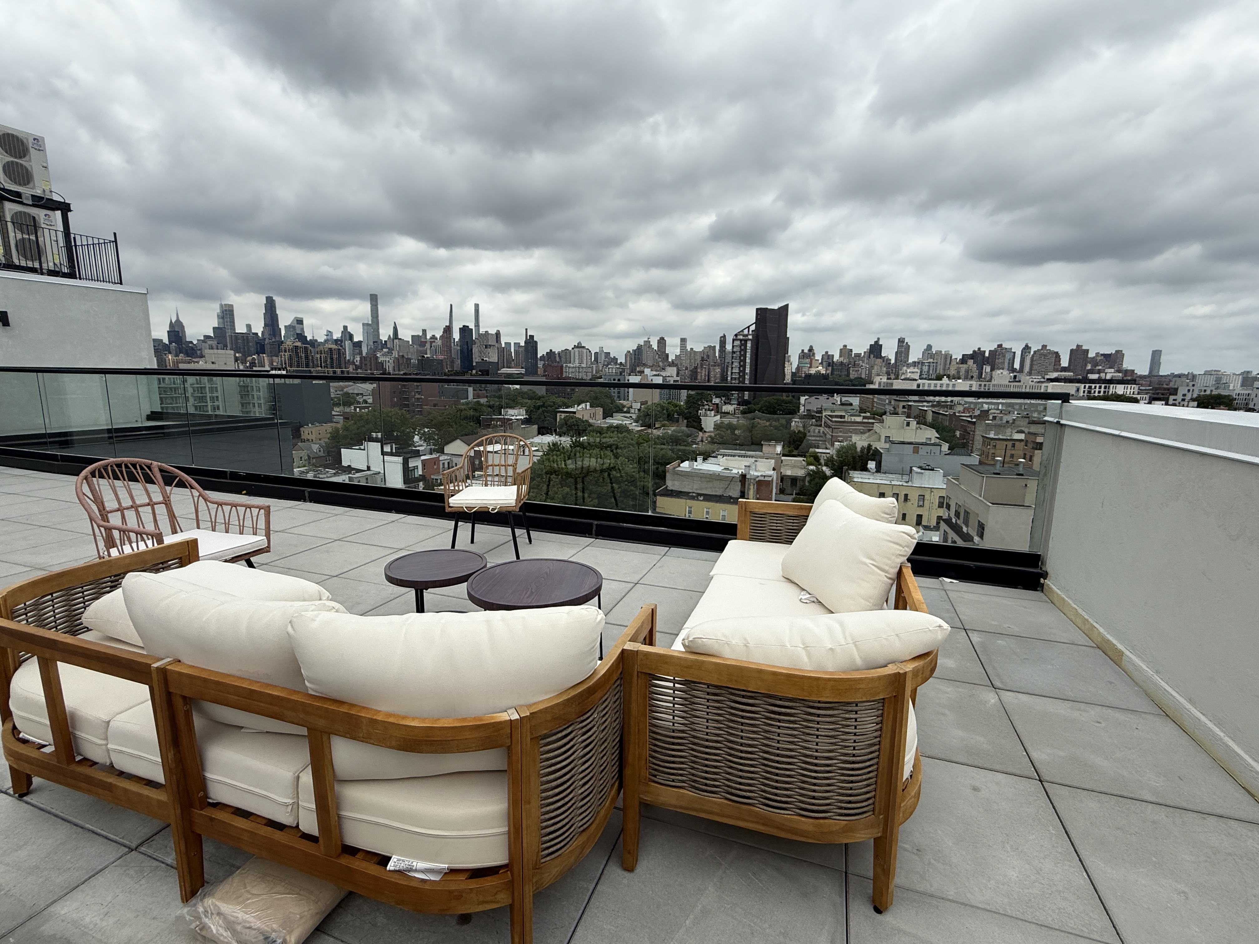 31-16 21st Street, Unit 3E Queens, NY 11106 - Photo 12 of 17 a roof deck with couches and a potted plant