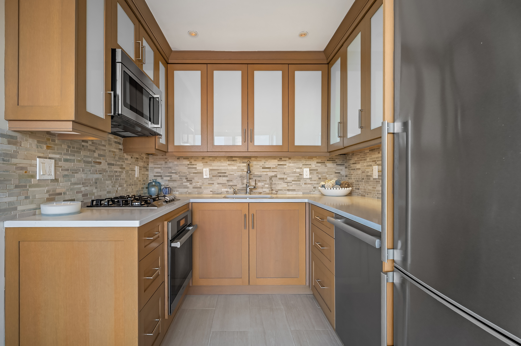 366 West 11th Street, Unit PHF Manhattan, NY 10014 - Photo 10 of 28 a kitchen with stainless steel appliances granite countertop a stove and a sink