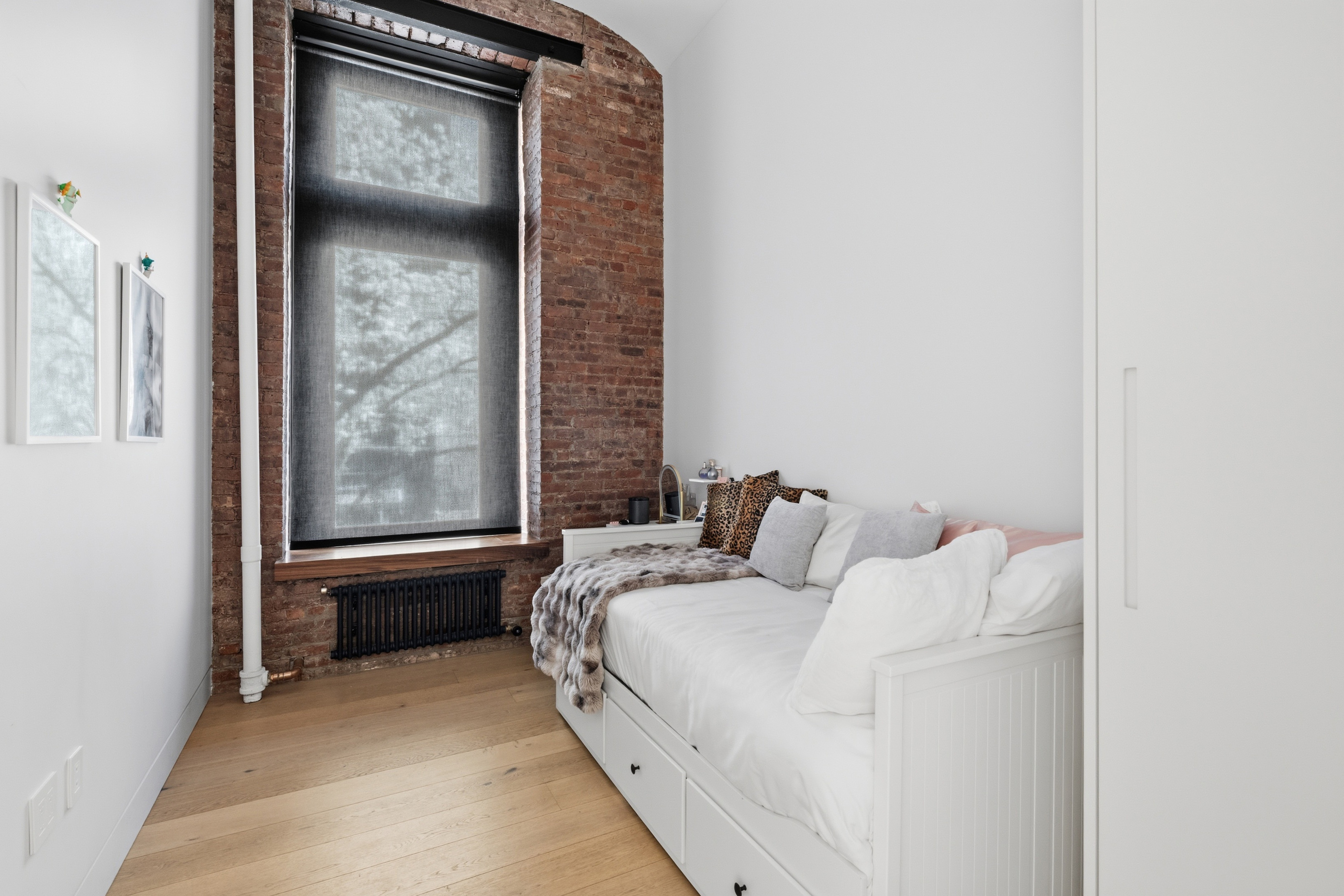 1 Great Jones St, Unit 2B Manhattan, NY 10012 - Photo 9 of 12 a bed room with a bed and a window