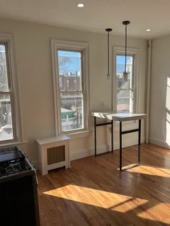 a workspace with wooden floor and a window