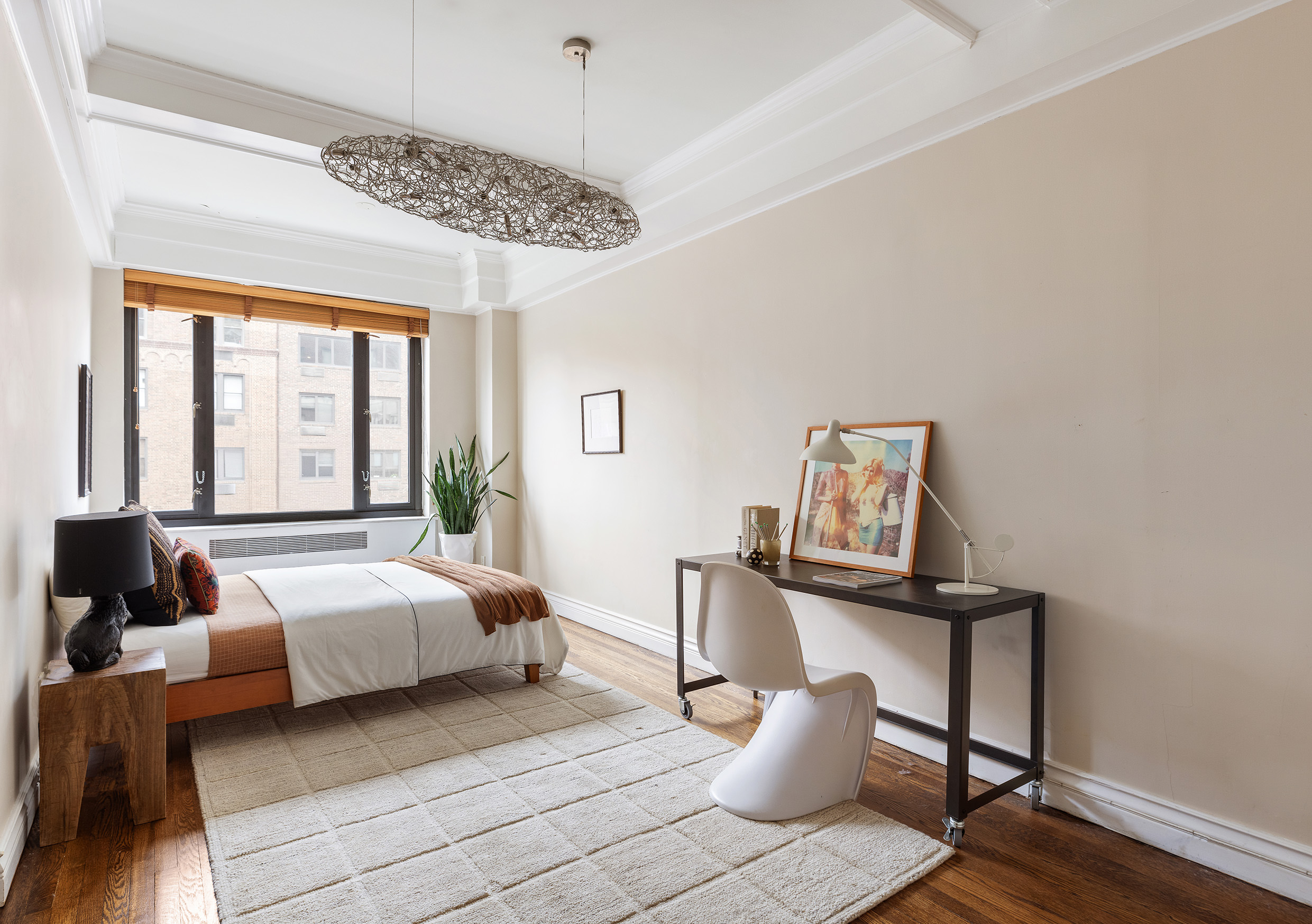 180 East 79th Street, Unit 14G Manhattan, NY 10075 - Photo 9 of 12 a bedroom with a bed and wooden floor