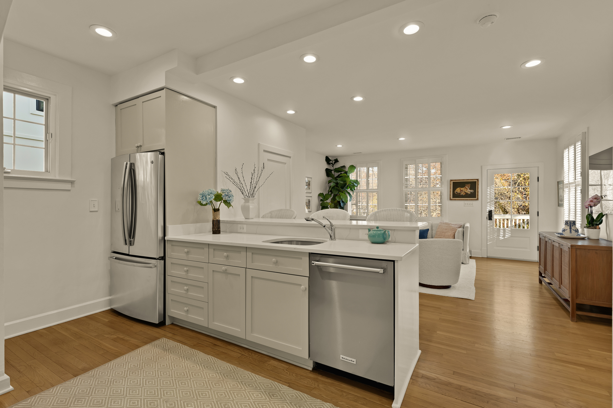 6815 Delaware Street Chevy Chase, MD 20815 - Photo 7 of 34 a kitchen with white cabinets and stainless steel appliances