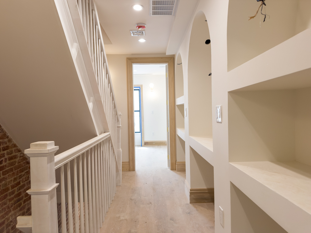 795 Quincy Street Brooklyn, NY 11221 - Photo 9 of 17 a view of a hallway with bathroom and wooden floor