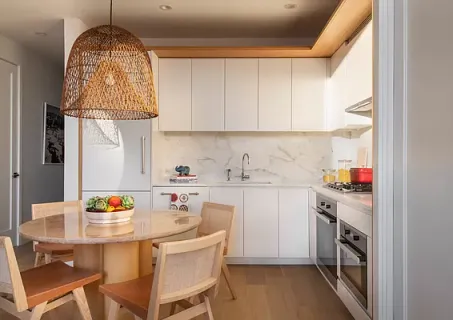 a kitchen with stainless steel appliances granite countertop a sink dishwasher and white cabinets with wooden floor