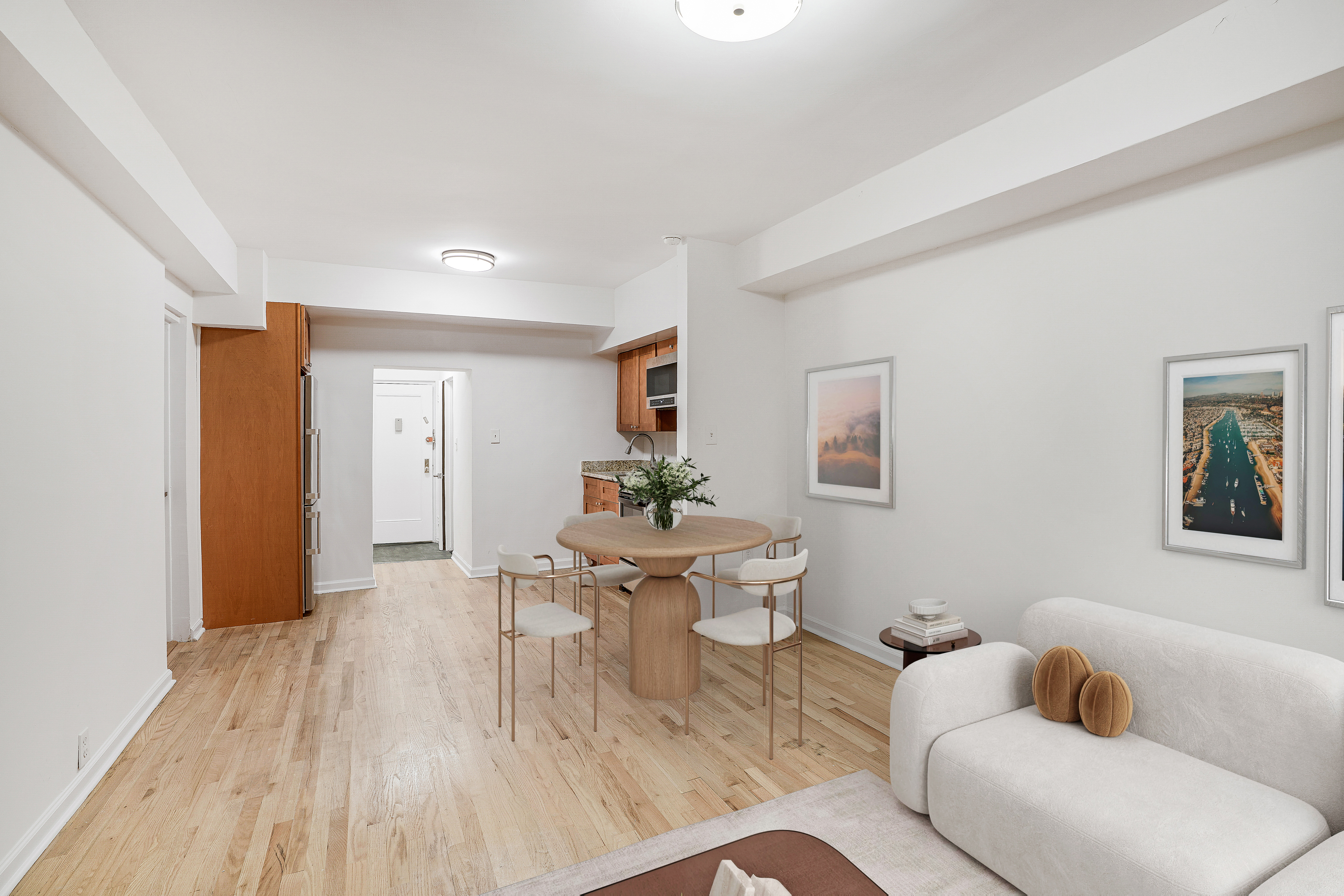 433 East 83rd Street, Unit B2 Manhattan, NY 10028 - Photo 3 of 5 a living room with furniture and a wooden floor