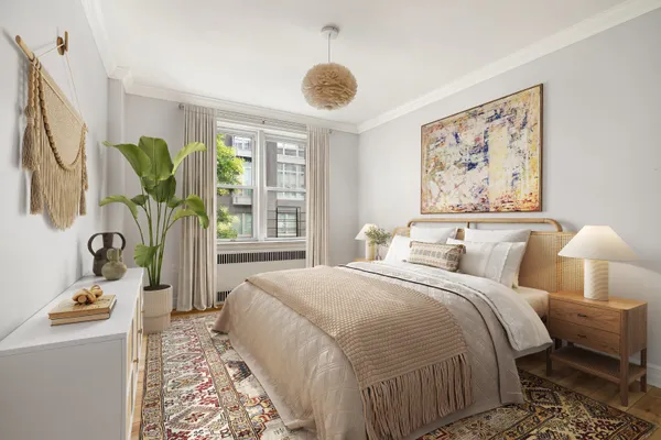 a bedroom with bed and a large window